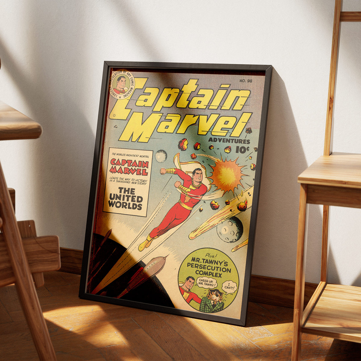 Captain Marvel Adventures No. 98 poster, leaning on the floor beside a chair
